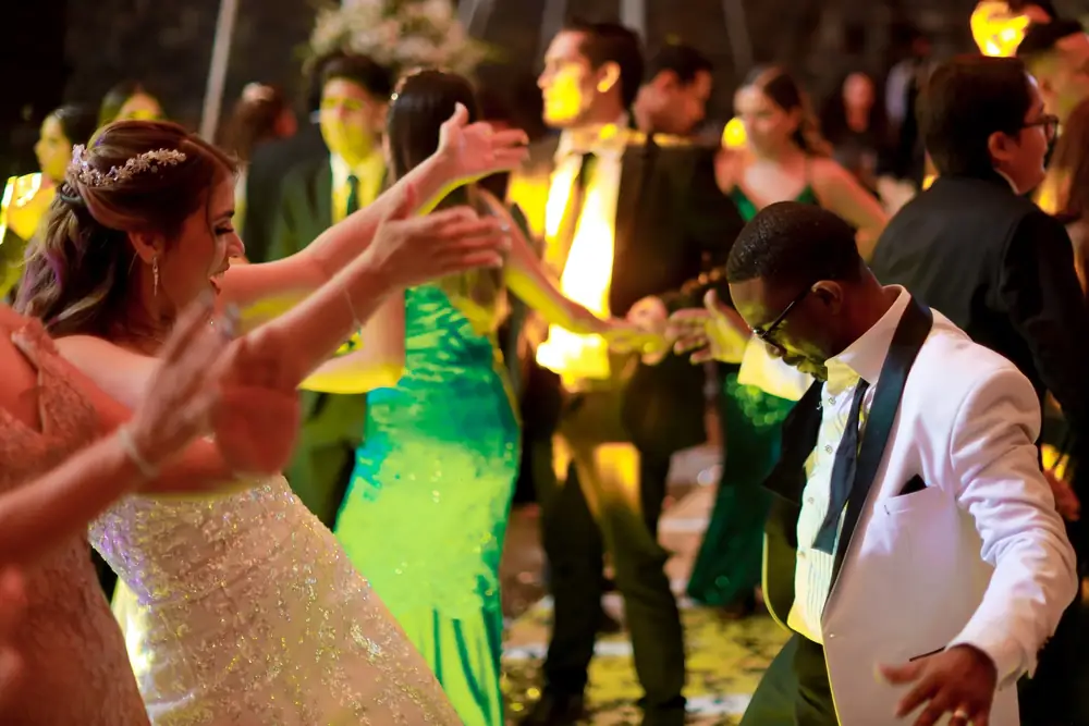 DJ hyping a wedding with a full dance floor